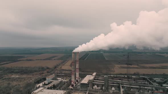 Aerial View of Oil and Gas Petrochemical Base Industry and Oil Refinery at Sunset in Cloudy Weather alt