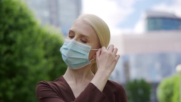 A Woman Tired of Quarantine Takes Off Her Medical Mask and Enjoys the Fresh Air