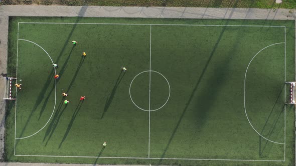 Top View of a Sports Football Field with Players Playing Football