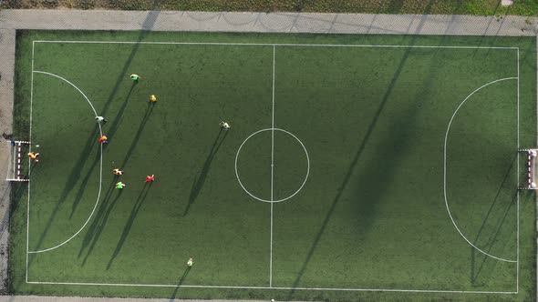 Top View of a Sports Football Field with Players Playing Football alt