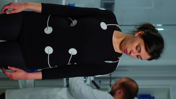 Vertical Video Scientist Researcher Preparing Woman Patient for Endurance Test alt