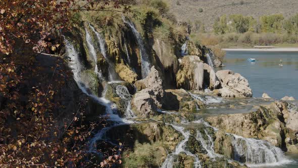 Fall Creek Falls along the Snake river with people floating the river alt