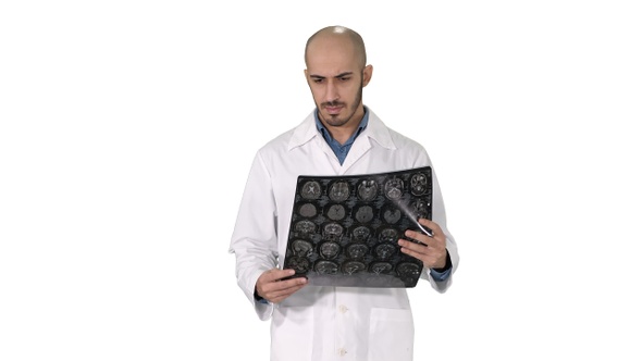 Arabian physician reviewing a MRI brain scan while walking alt