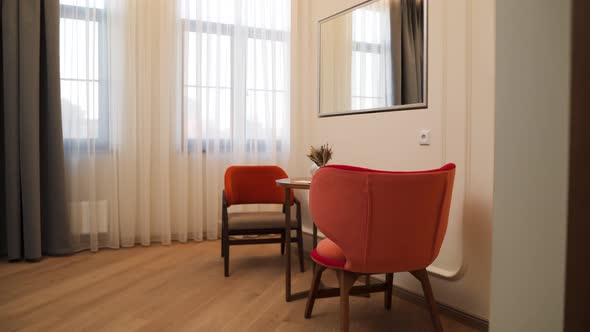 Coral Armchairs Stand in a Beautiful Living Room of a Downtown Hotel