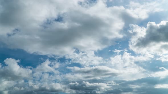 Building motions clouds. Puffy fluffy white clouds sky time lapse.