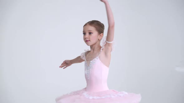 Young Female and Little Girl in a White Tutu Dance Ballet and Perform Choreographic Elements on a alt