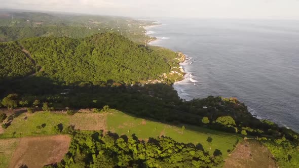 Beach Reveal from Above, Tropical Lush Hills into the Ocean