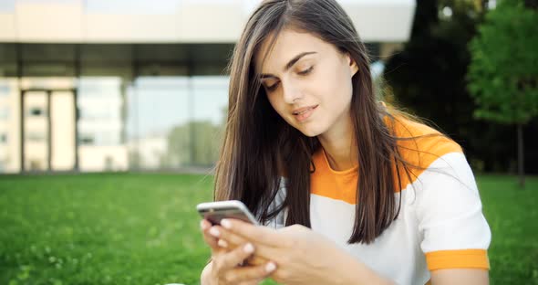 Smiling Woman Texting on Smartphone