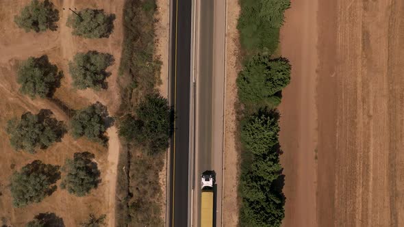 Truck loaded with Shipping container on a rural highway. alt
