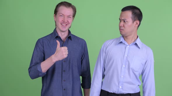 Two Multi Ethnic Businessmen Having Different Opinions Together alt