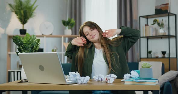 Female Worker Raising Her Head from the Table Falls Asleep Working on Start Up Proejct at Home alt