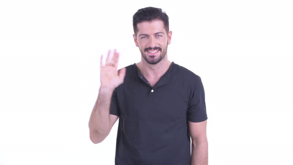 Happy Young Handsome Bearded Man Waving Hands alt