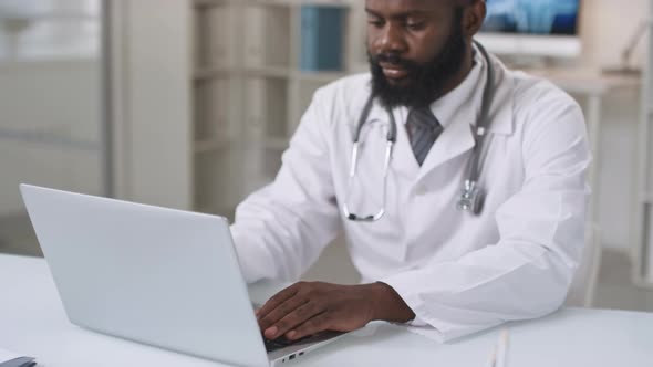 African American Doctor Using Laptop alt