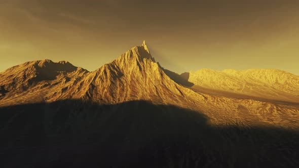 Mountain peak on a vast, natural desert during a beautiful sunset in the summer. alt