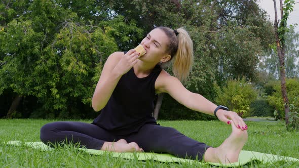 Girl Stretches on Exercise Mat and Bites Off Pie alt