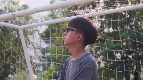 Portrait of a confident young man wearing glasses and wearing a casual gray t-shirt crossed arms in alt