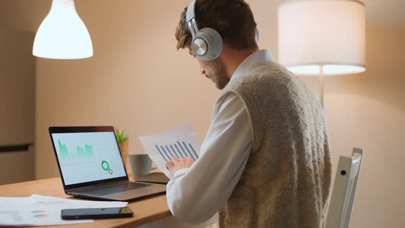 Man Financial Analyst on a Remote Work at Home Working with Documents and Financial Statements View alt