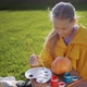 A Child Paints a Pumpkin Prepares Decorations for Halloween - VideoHive Item for Sale