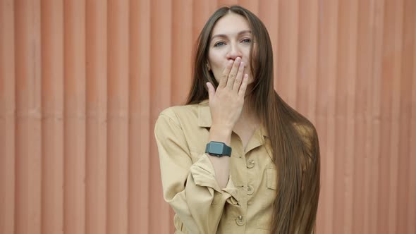 Slow Motion of Beautiful Girl Sending Air Kiss and Smiling Flirting Standing Outside Alone alt