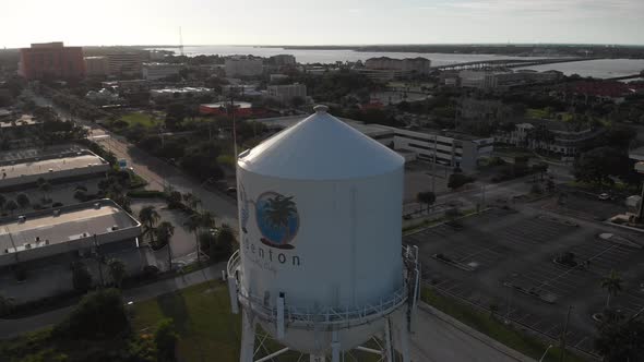 Welcome to Bradenton, Florida at sunset.  Aerial water tower orbit with surrounding cityscape in the alt