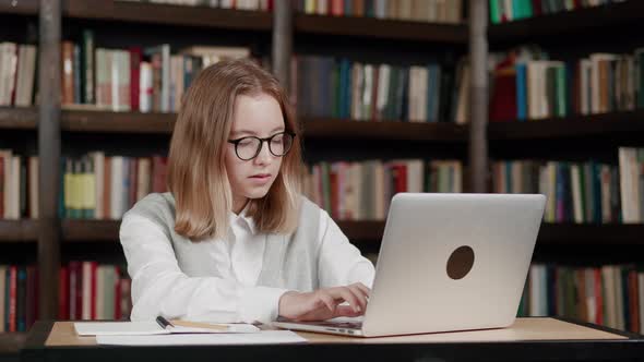 Girl Using Laptop Computer Typing the Text Watching Distance Online Learning Seminar Class Remote alt