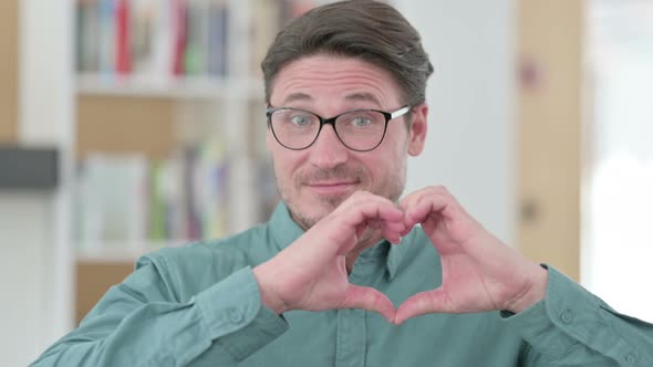 Middle Aged Man Showing Heart Sign By Hand alt