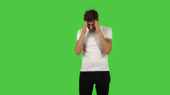Confident Guy Is Suffering From Headache From Fatigue. Green Screen alt
