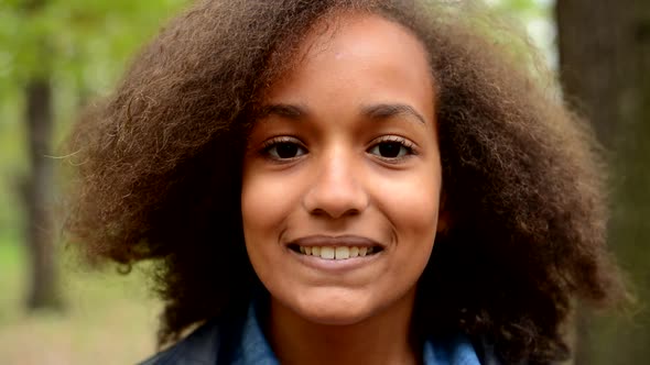 Young Happy African Girl Turn To the Camera and Smile in To Camera - Eye Contact - Face Detail alt