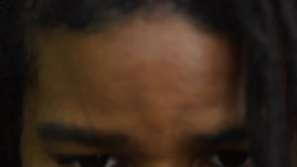 Young Man With Nose Ring Looks Up And Stares Into Camera Extreme Close Up