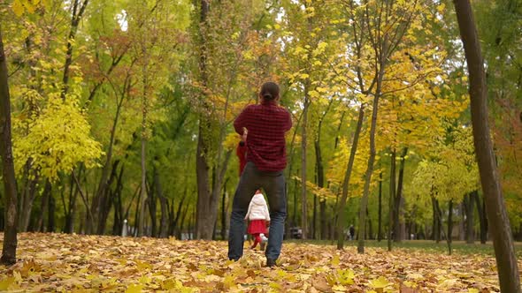 Two Happy Funny Family Daddy Children Kids Have Fun in Park with Dad Enjoying Autumn Fall Nature