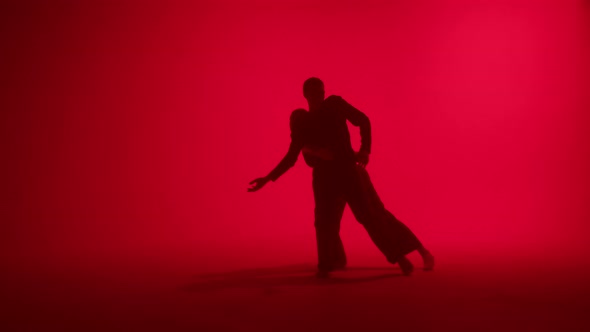 Professional Choreographers Dancing Contemporary on Red Neon Background in Studio alt