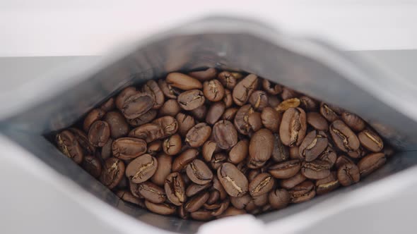 A Package of Freshly Roasted High Quality Coffee Closeup of Arabica Coffee Beans