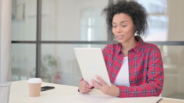 African Woman Making Video Call on Tablet alt