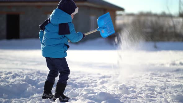 Little Boy Shoveling Snow at Winter alt