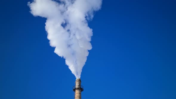 Pollution and smoke in the form of a heart in the blue sky in the spring