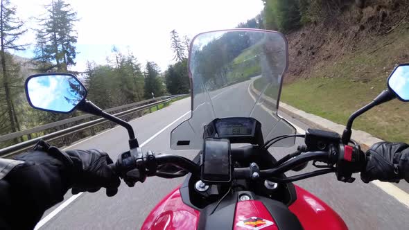 Motorcyclist Rides on Beautiful Landscape Mountain Road Near Snowy Switzerland Alps alt