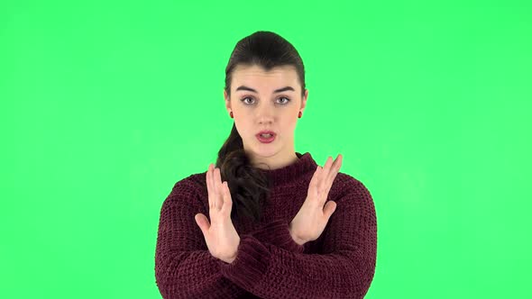 Woman Strictly Gesturing with Hands Crossed Making X Shape Meaning Denial Saying NO. Green Screen alt