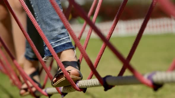 Kids walking on a rope bridge in the garden 4k alt