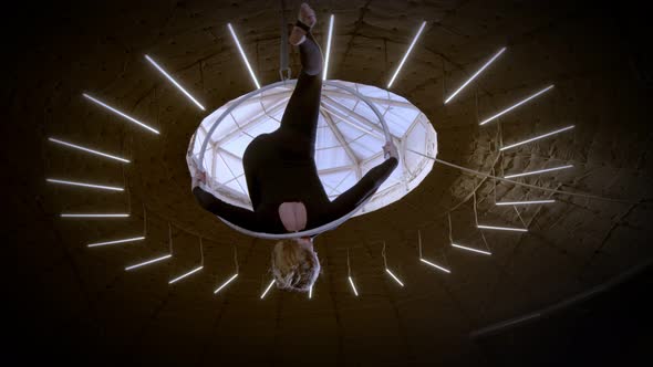 Female Gymnast Performing the Acrobatic Elements Upside on the Aerial Hoop