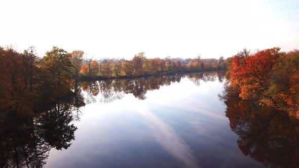 Aerial View. Flying over the beautiful autumn River. Aerial camera shot alt