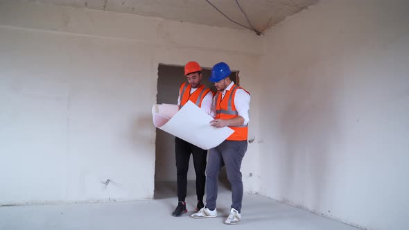 Male Contractors Examining Draft Together alt