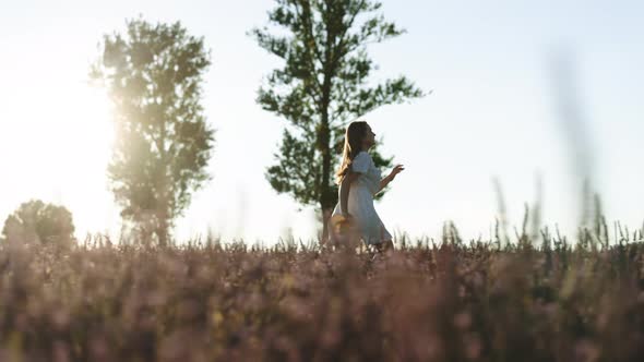 Female Tourist in Sundress Running on Lavender Field Enjoying Trip to France