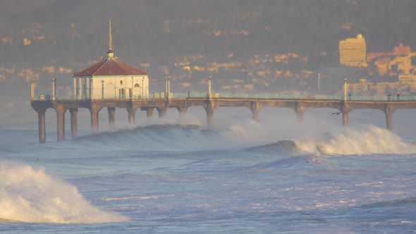 The Manhattan Beach Pier stands majestic over the Pacific Ocean. alt