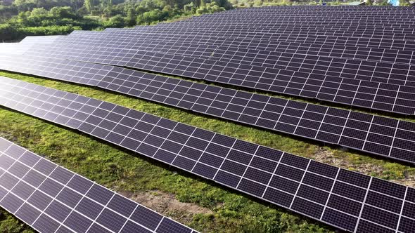 Aerial Top view on Solar Power Station in Green Field on Sunny day alt