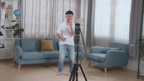 Asian Boy Dancing While Shooting Video Content For Social Networks With A Smartphone Camera alt