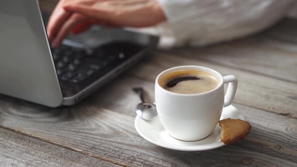 Woman Is Working On Laptop. Woman's Hand Is Typing On  Notebook Computer Keyboard In The Office alt