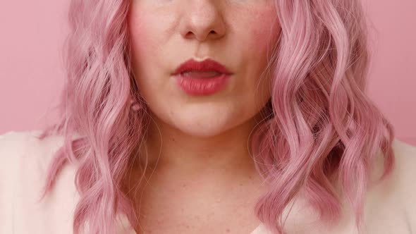 Positive Dreamy Young Pink Hair Woman Sending Air Kiss to Camera Isolated Over Pink Background