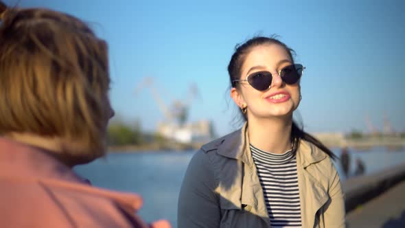 Young Happy Woman Talking with Friend Laughing Walking on Quay