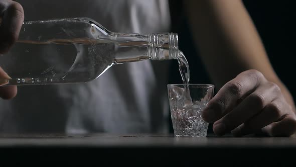Close Up of Man Drinking Vodka in a Dark Room in Slow Motion