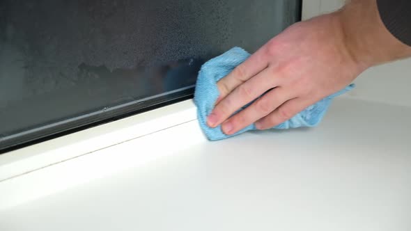 A Man Washes the Joints on Window with a Steam Cleaner
